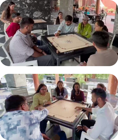 Team members enjoying a friendly game of carrom during the trip